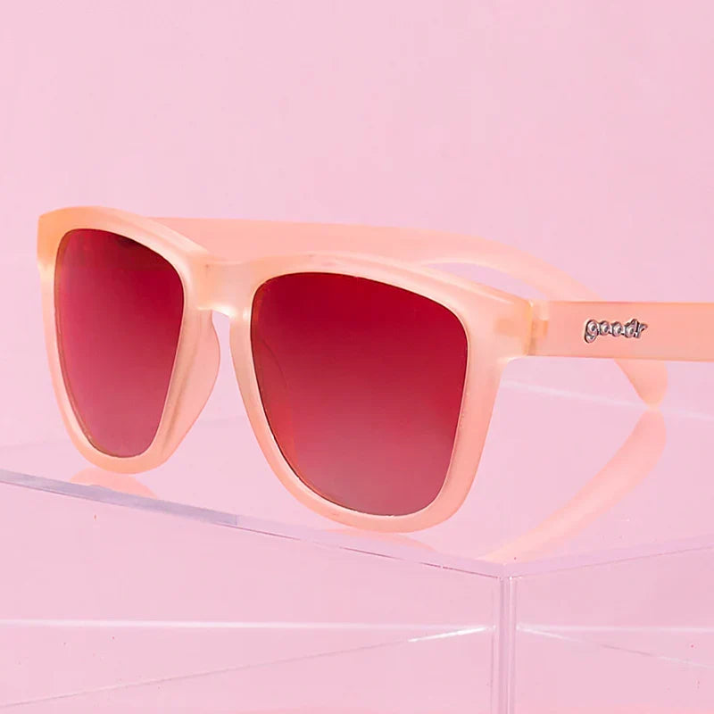 Pink square-shaped sunglasses with pink gradient lenses. 